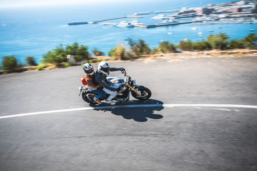 Guided motorcycle tour group riding together on a scenic mountain road